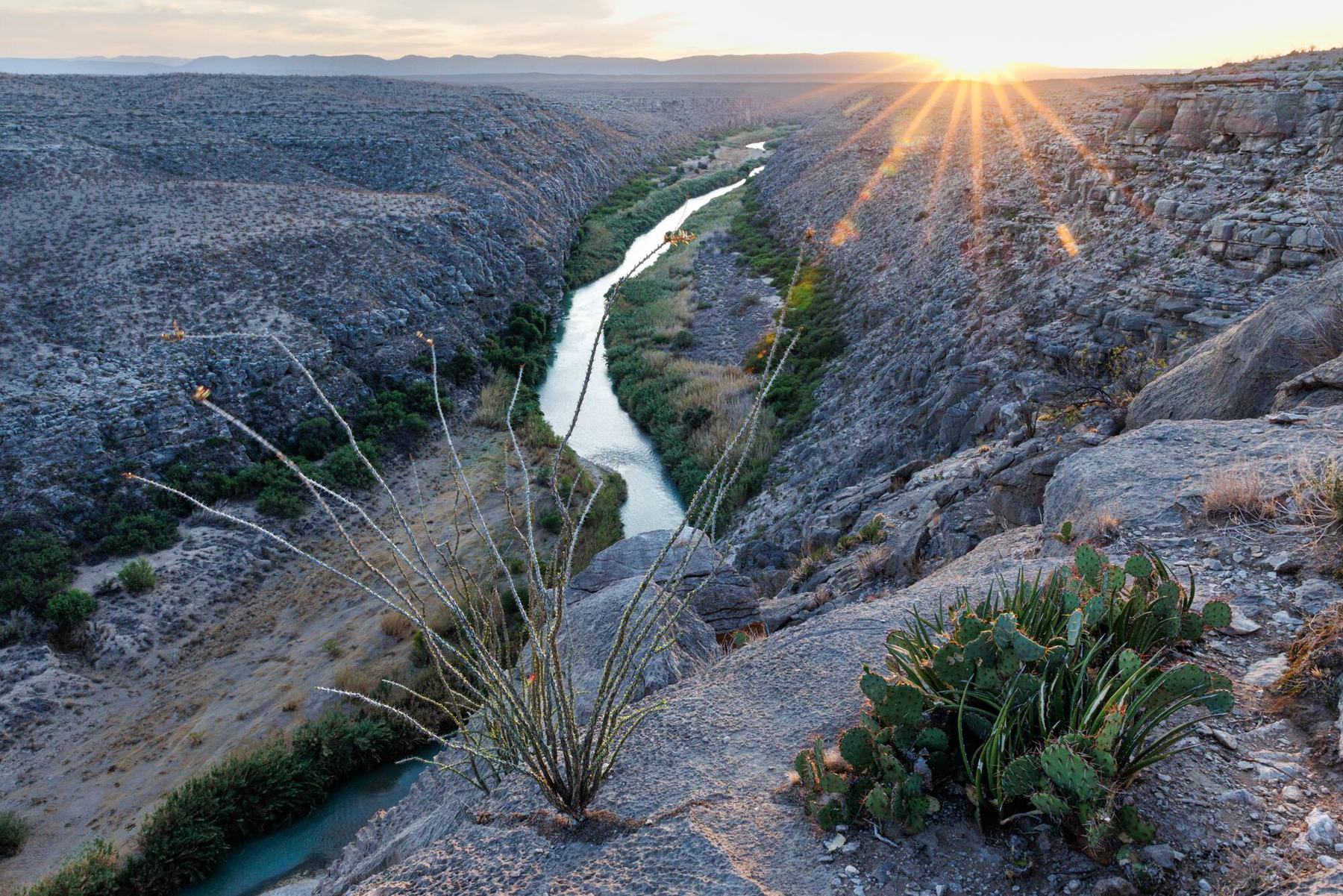 Sunburst over the Rio Grande winding through deep canyons