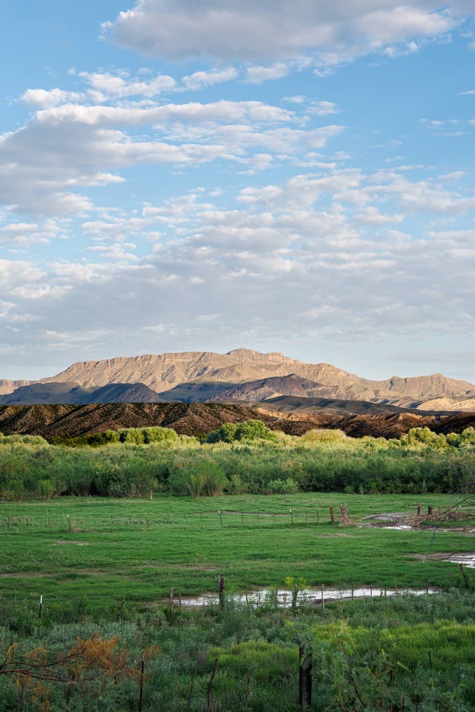 Green fields and a mesa along Chispa Road