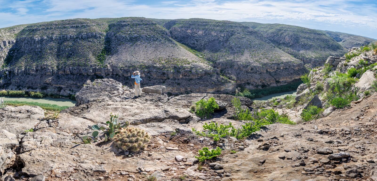 Jill Goodson standing on a canyon rim above the Rio Grande